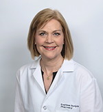 Susan smiles in her white lab coat.