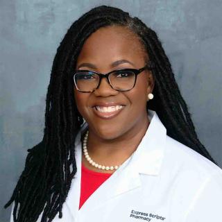 Christina Wilson-Smith, a registered pharmacist with Express Scripts® Pharmacy, smiles in her lab coat.